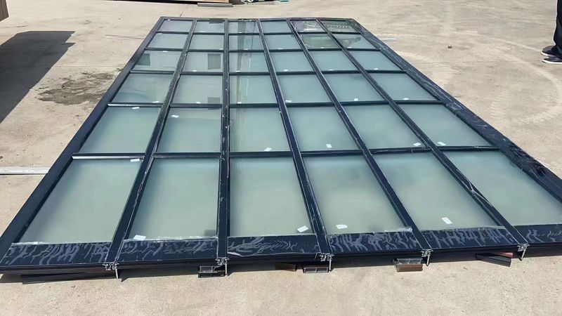 Modern full-view glass French-style garage door with black aluminum frame